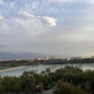 с с видом на горы и озеро Алматы